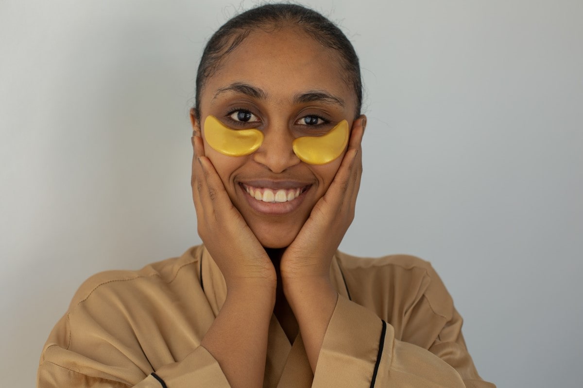 smiling woman applied under eye mask