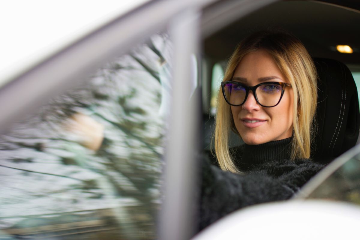 woman wearing a pair of glasses while driving