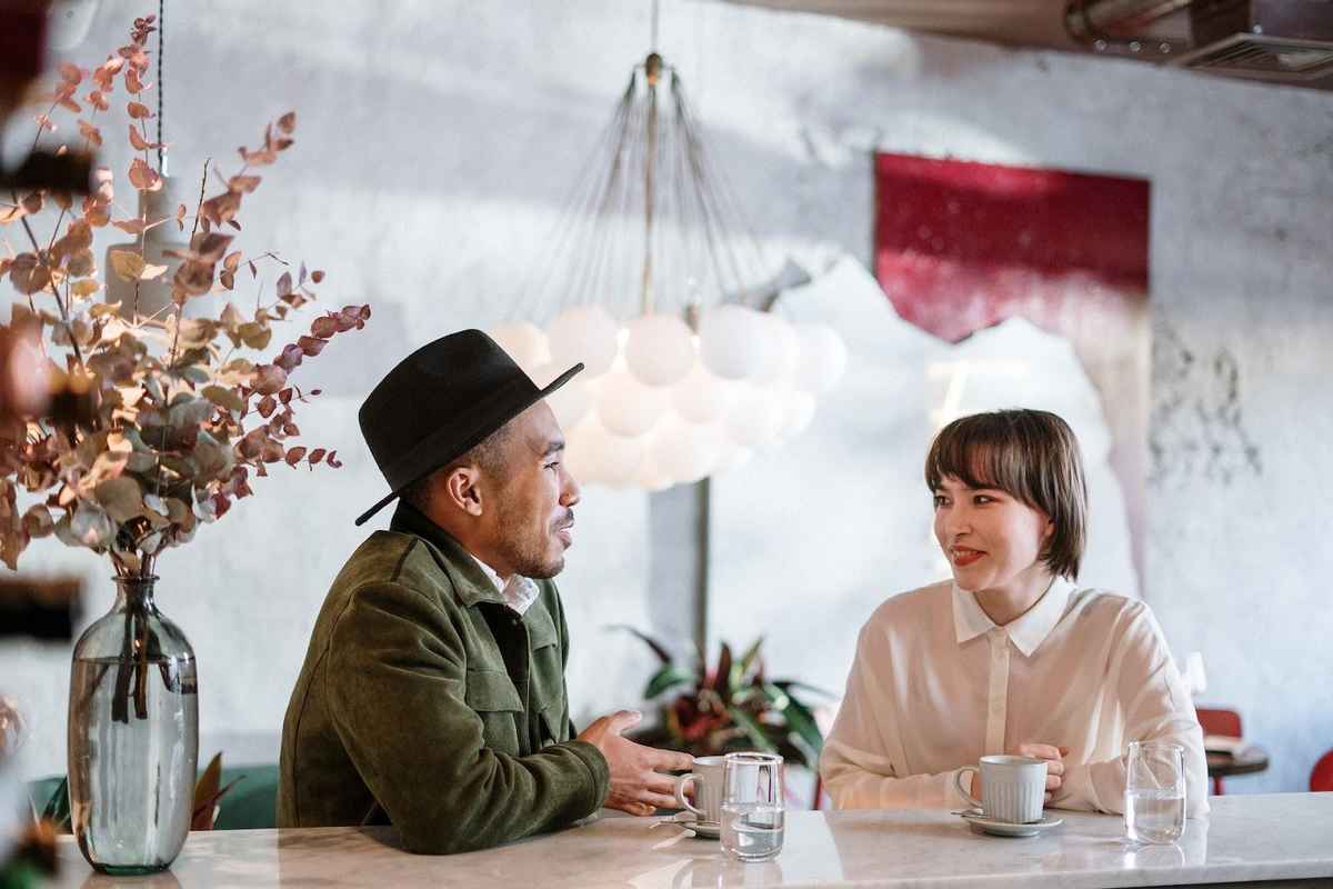 two people maintaining eye contact while conversing over coffee