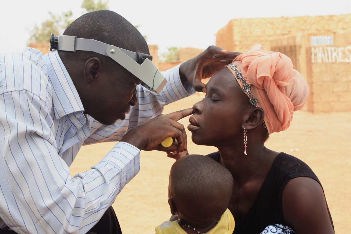 eye doctor helping someone to remove foreign object out of their eyes