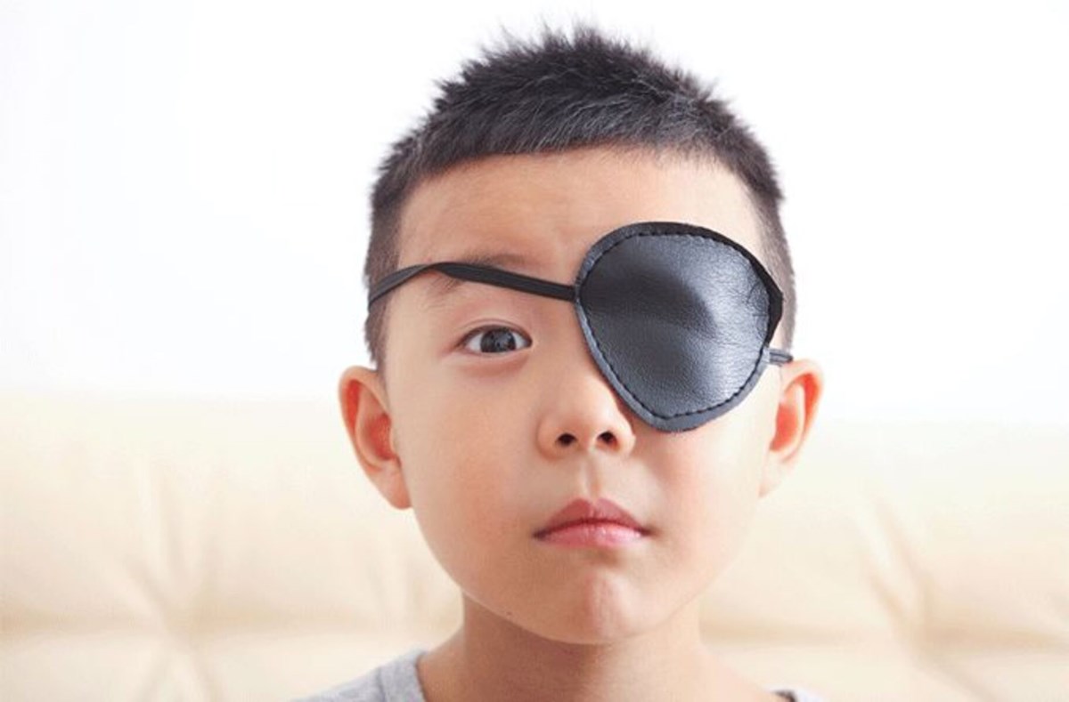kid wearing a big black eyepatch