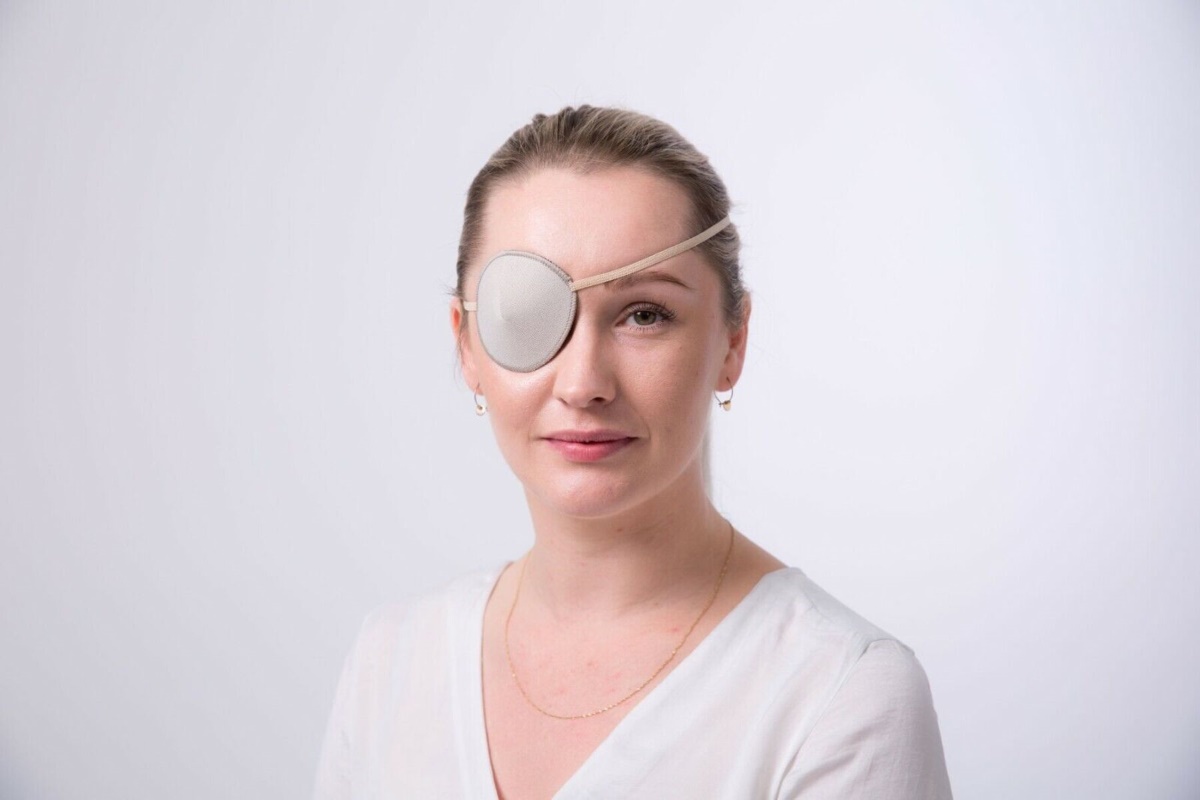 a woman wearing a white eyepatch for medical purposes