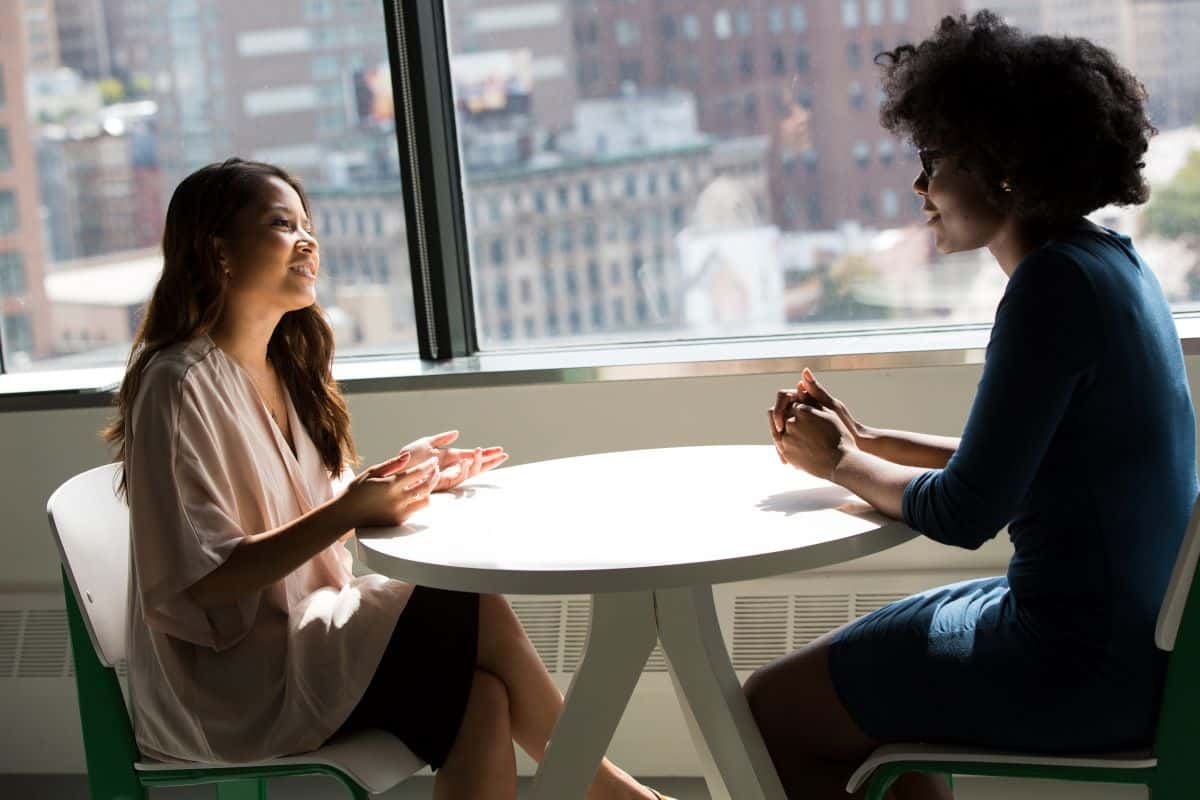 two people practicing maintaining eye contact via talking face to face