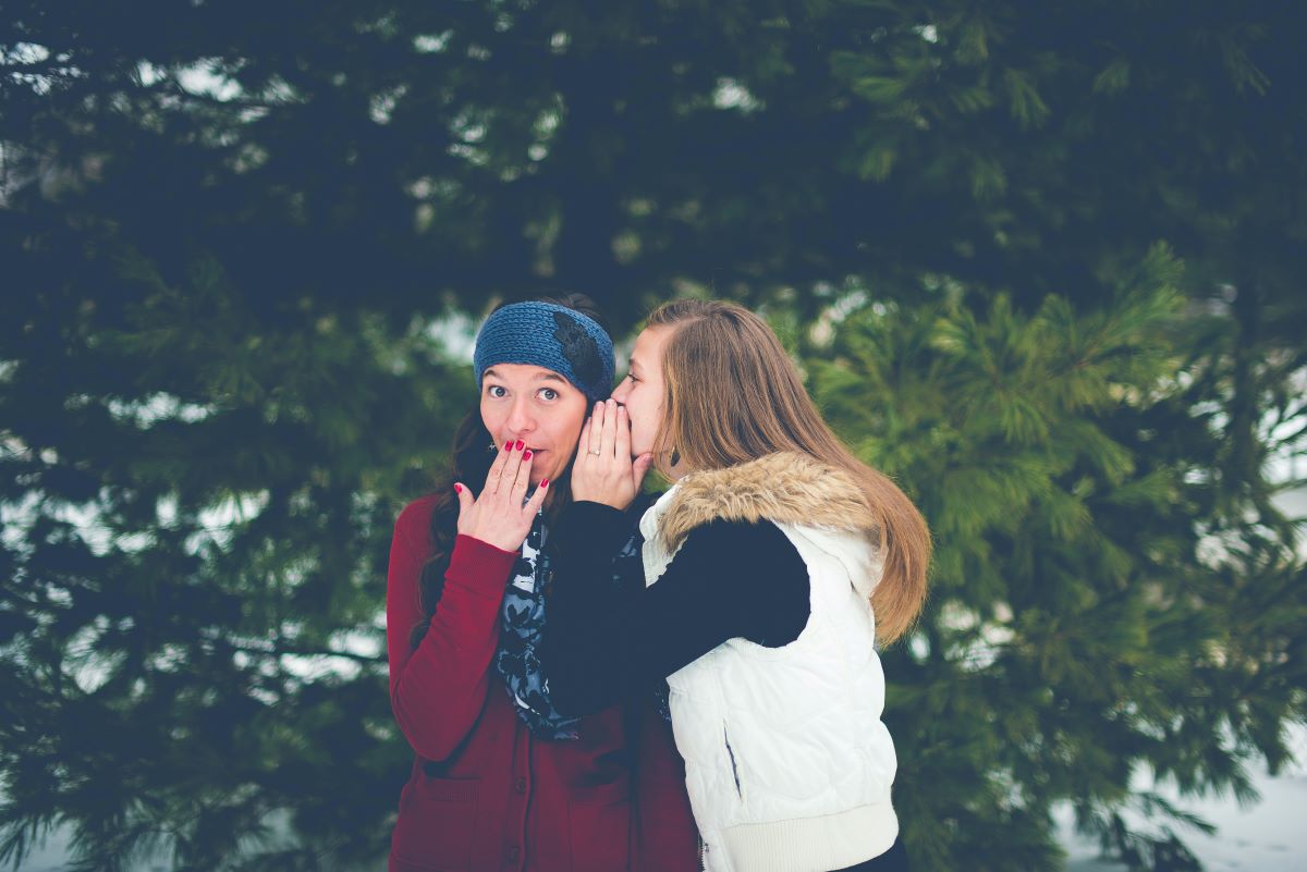 ladies whispering to each other