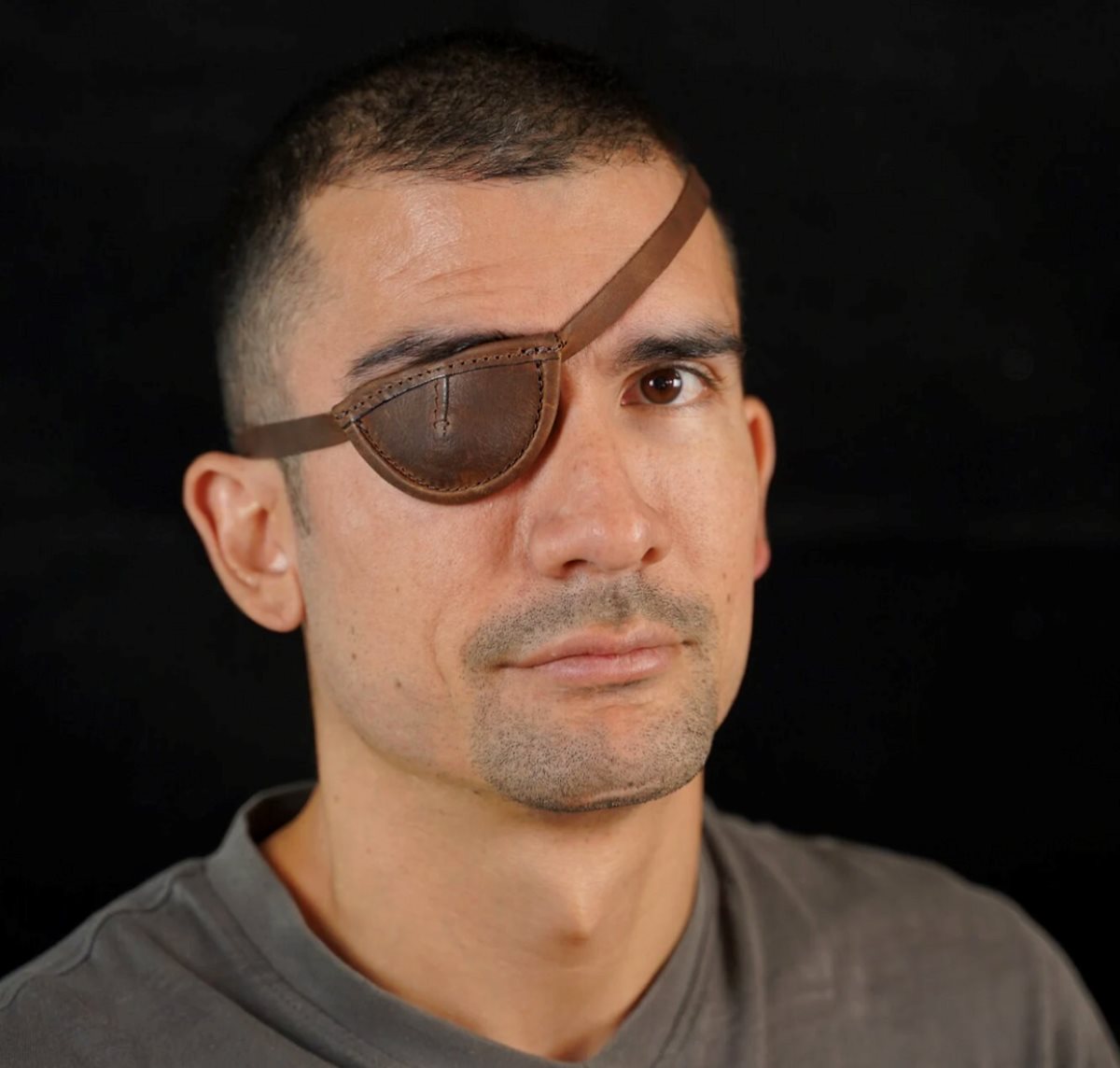 man wearing a leather eyepatch for decorative purposes