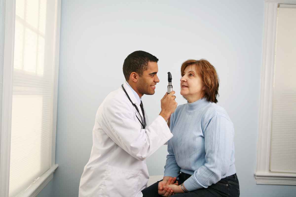 eye doctor performing eye checkup for a patient