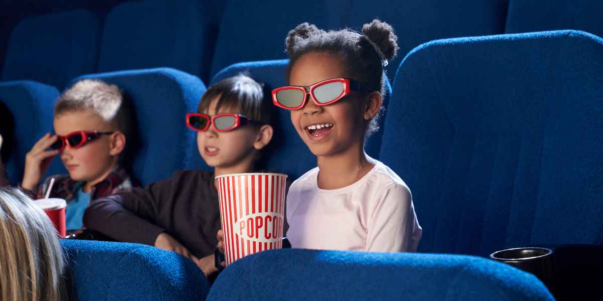 kids watching show wearing passive polarized 3d glasses in cinema