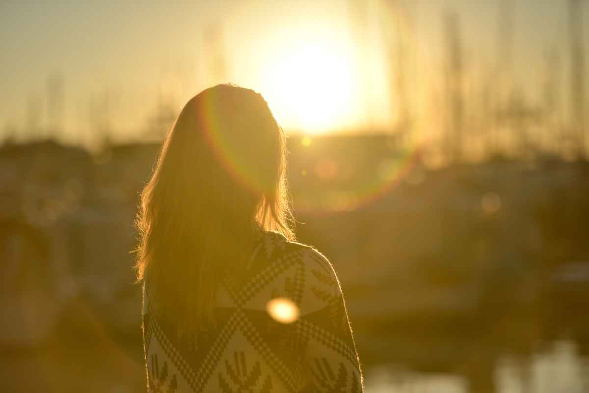 woman staring into sunset