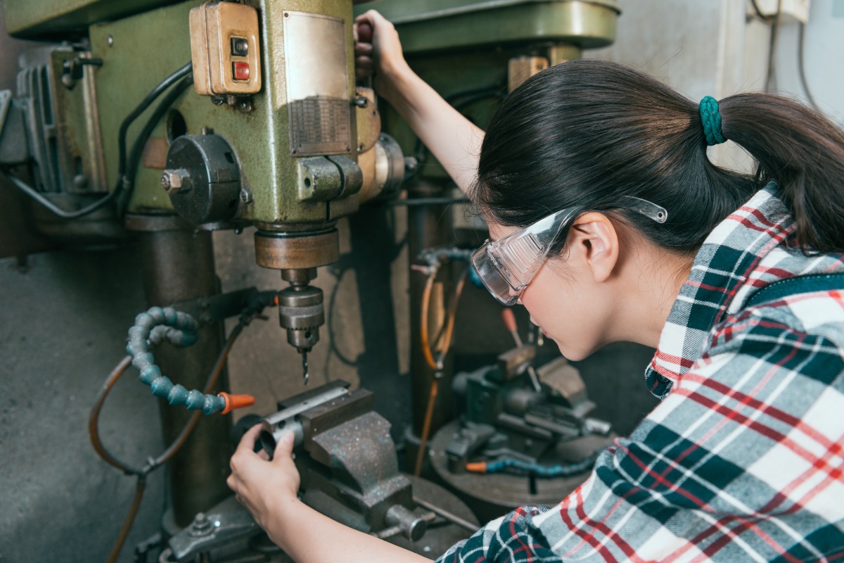 woman wearing safety glasses on work