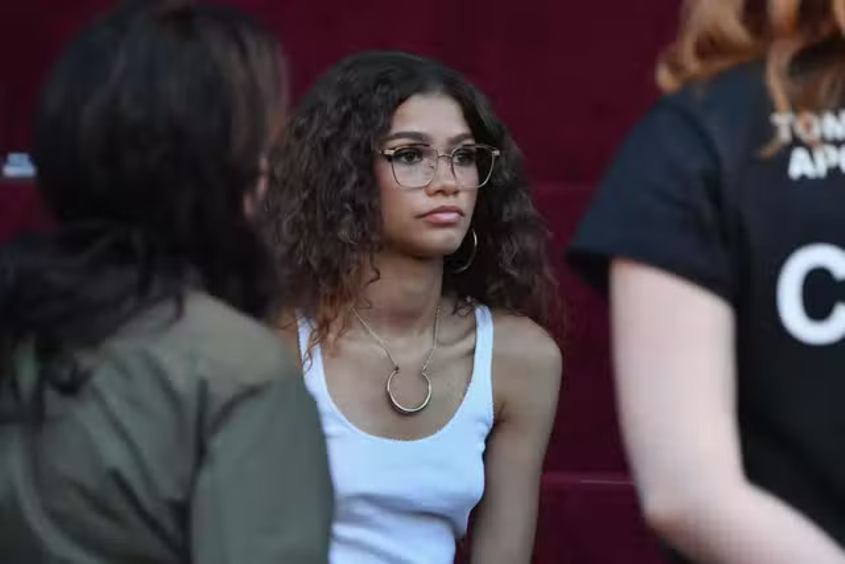 zendaya with curly hair wearing a pair of cat eye glasses