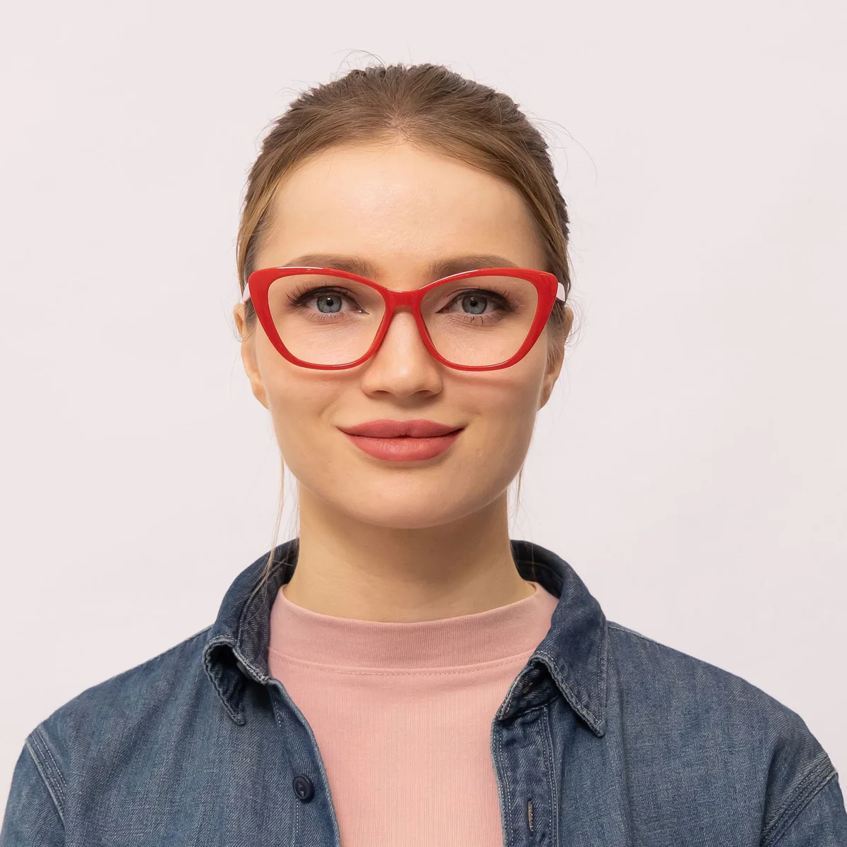 woman wears red cat eye glasses that makes her eyes appear bigger