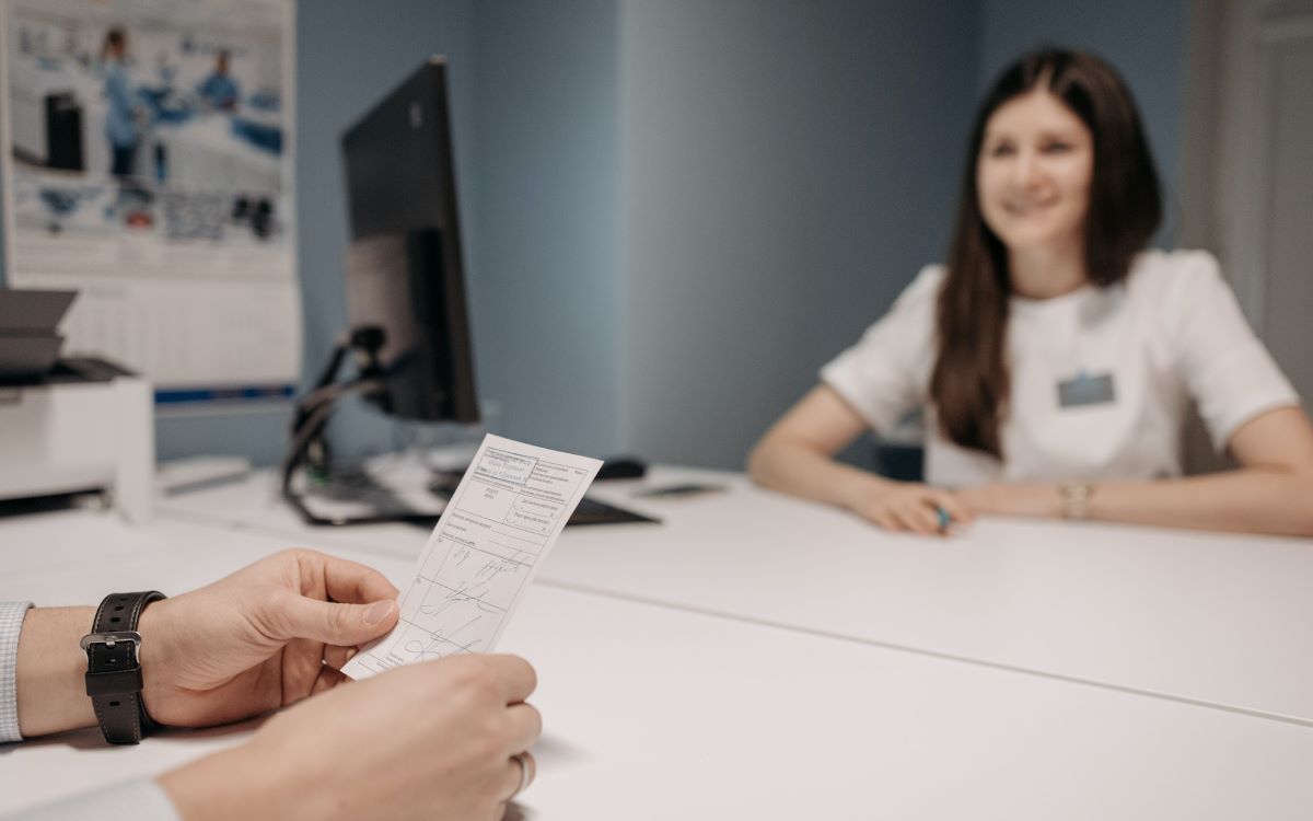 a woman updating her eye prescription with an eye doctor