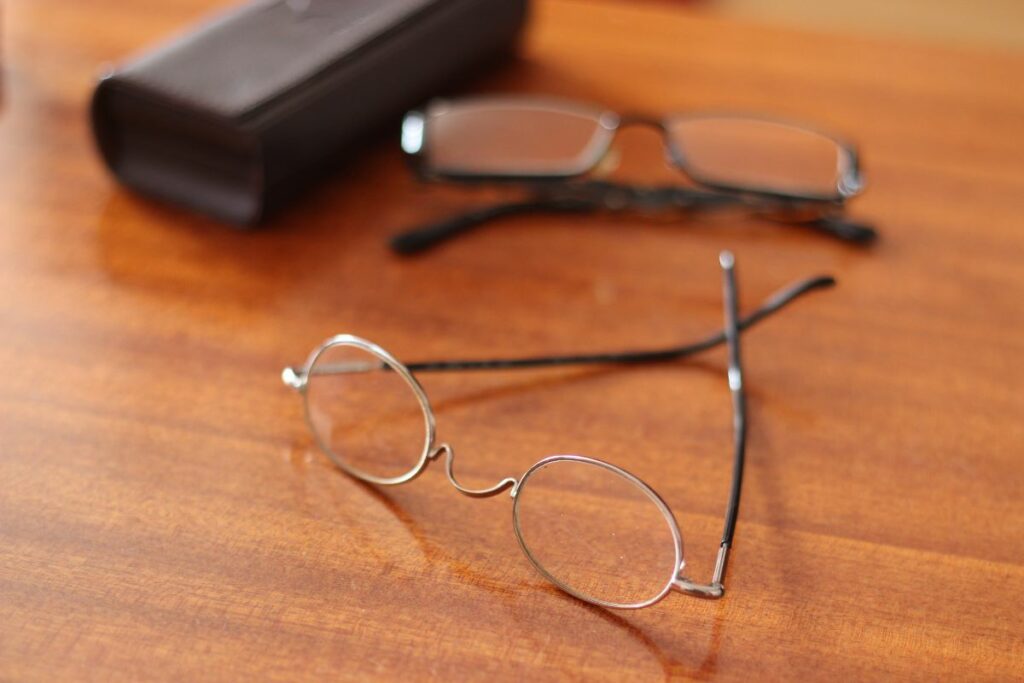 two pair of eyeglasses with one of them as backup