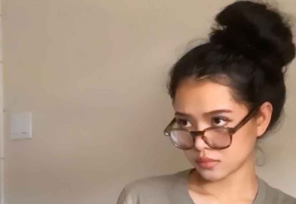 Bella Poarch rocking a casual look with a disheveled bun and stylish wooden spectacles