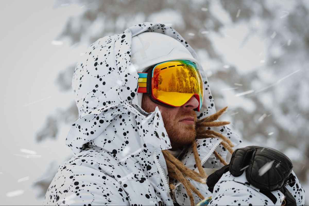 a man wearing a pair of goggles in snowy outdoors