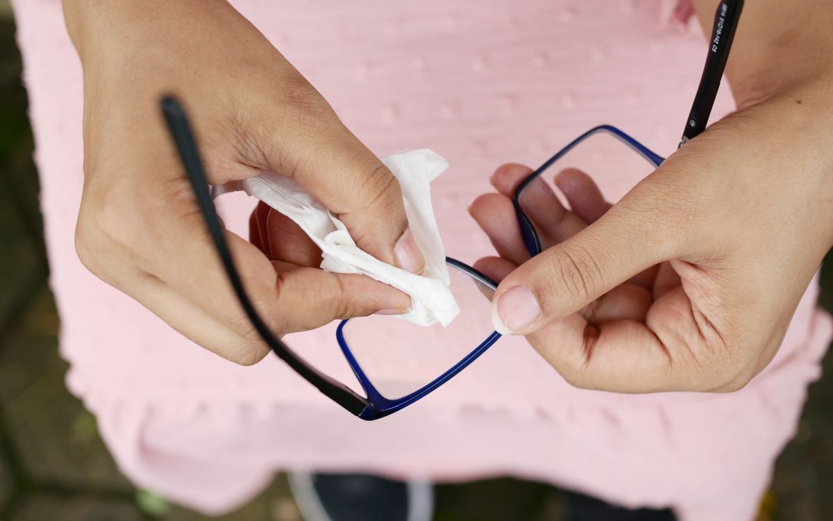 hands wiping glasses using cleaner cloth