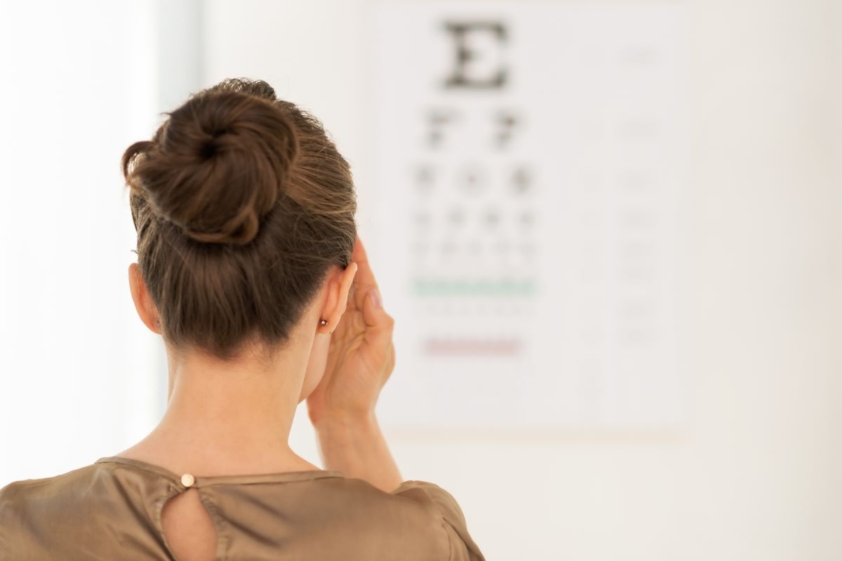 woman using snellen eye chart at home