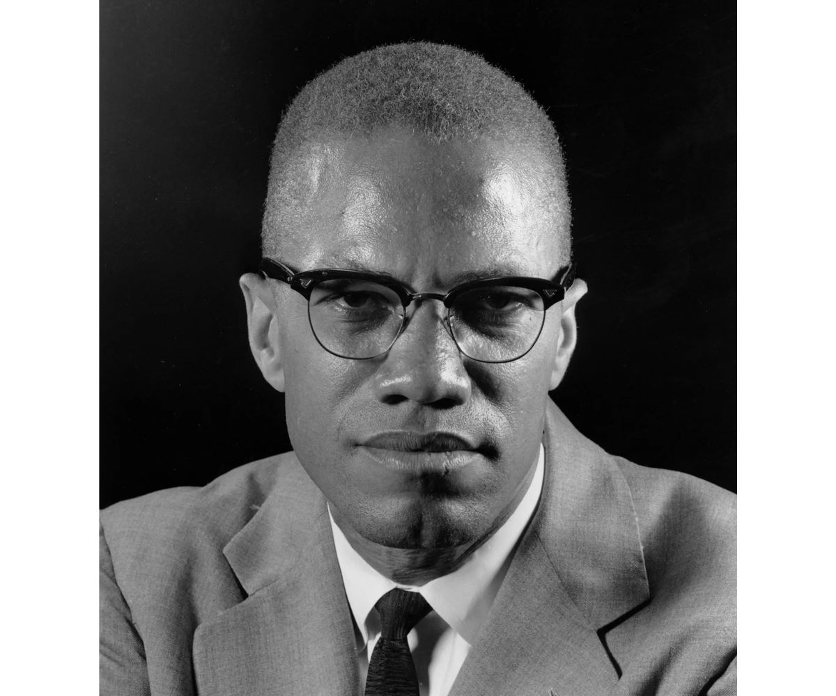 Malcolm X wears horn rimmed nerd glasses