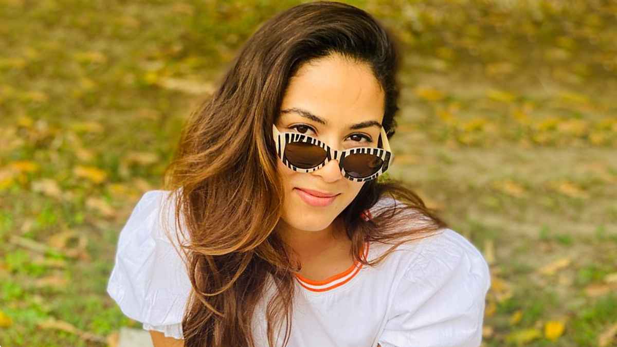 Mira Rajput Kapoor wears her bold zebra-striped glasses with a classic white blouse featuring bright orange piping