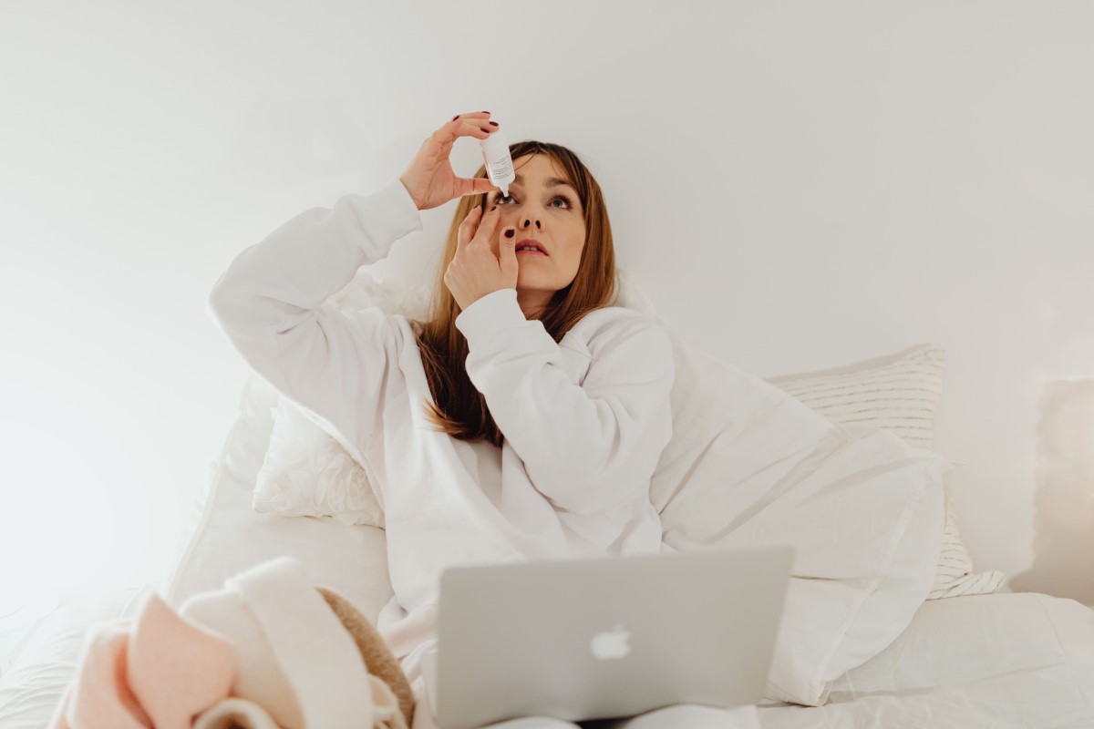 woman apply eye drops to relieve effects from sun exposure