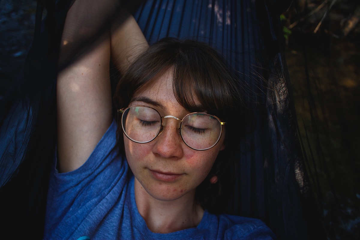a woman sleeping with glasses on