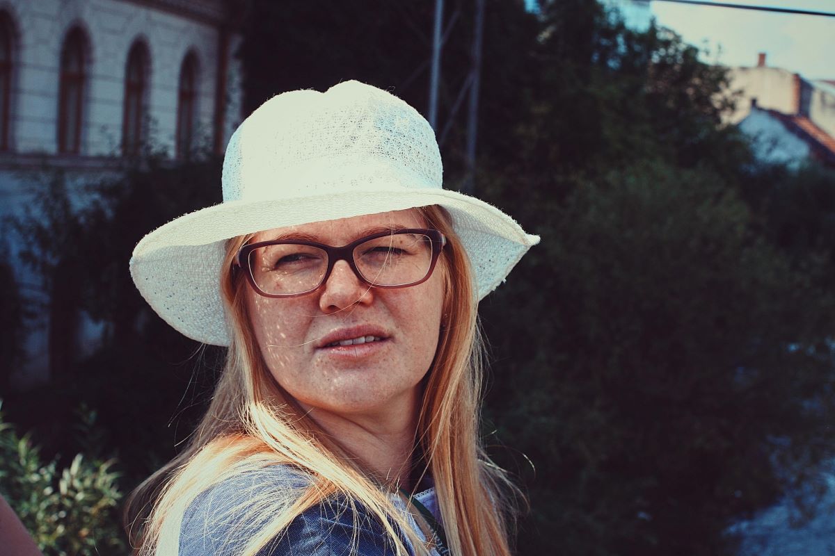 woman squinting with a pair of glasses