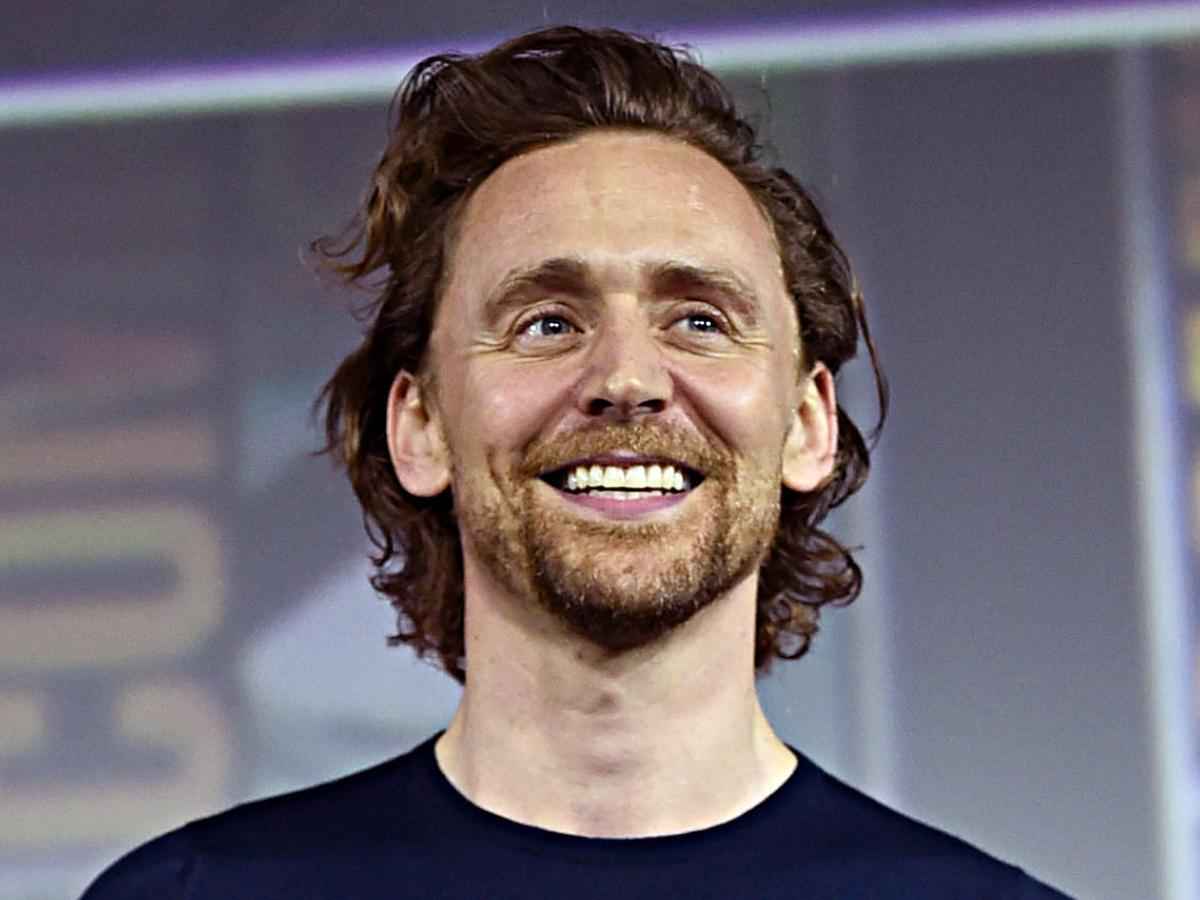 tom hiddleston with a big smile
