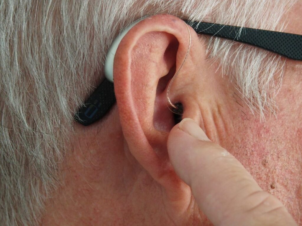 man with hearing aids and glasses