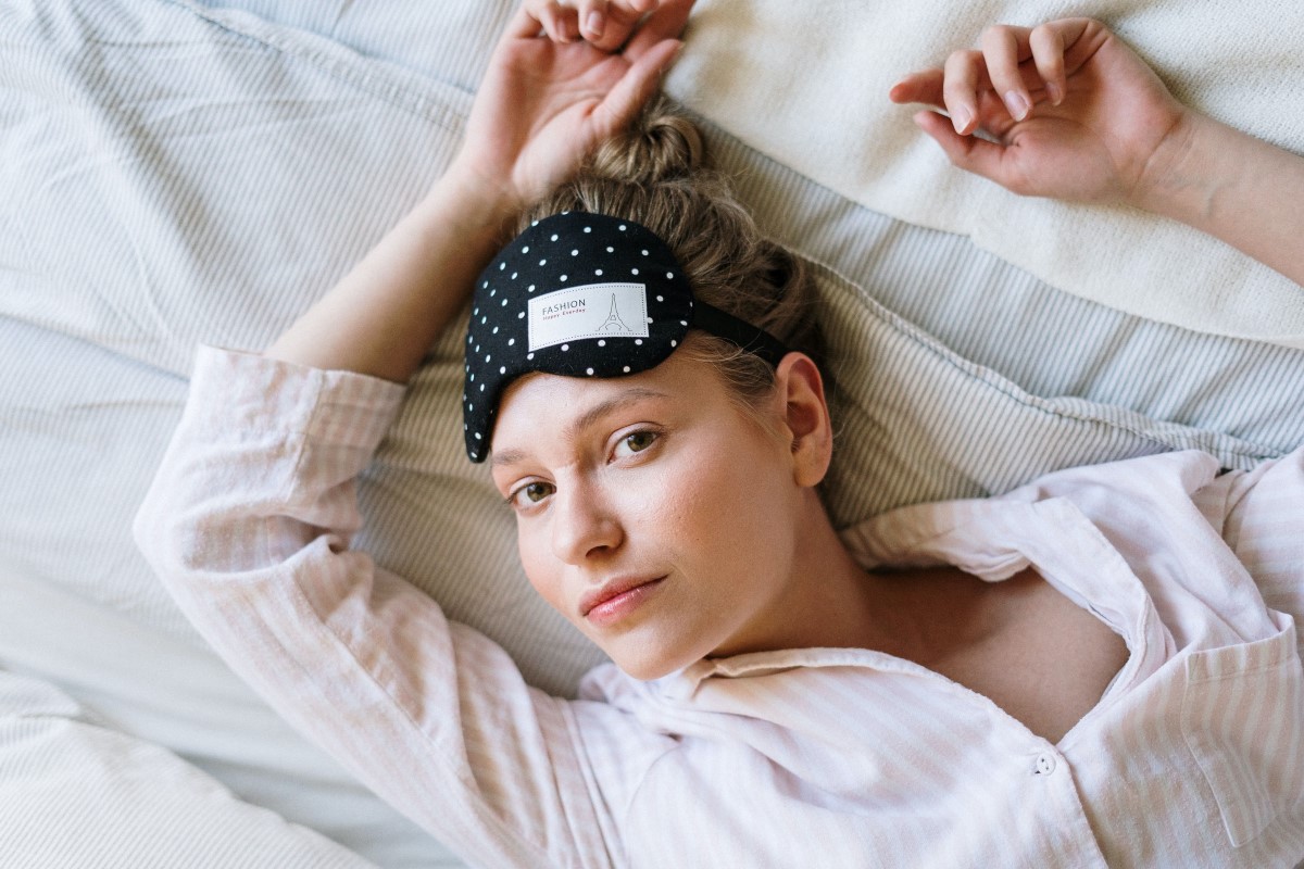 a woman wearing a dotted eye mask on the forehead