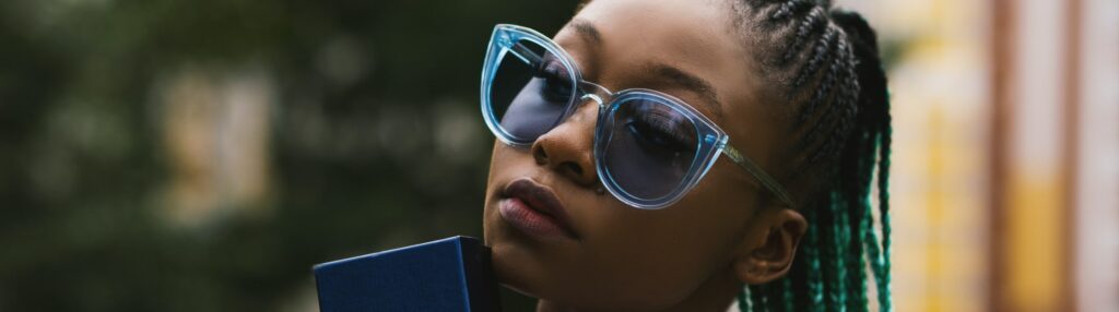 woman wears blue oversized glasses