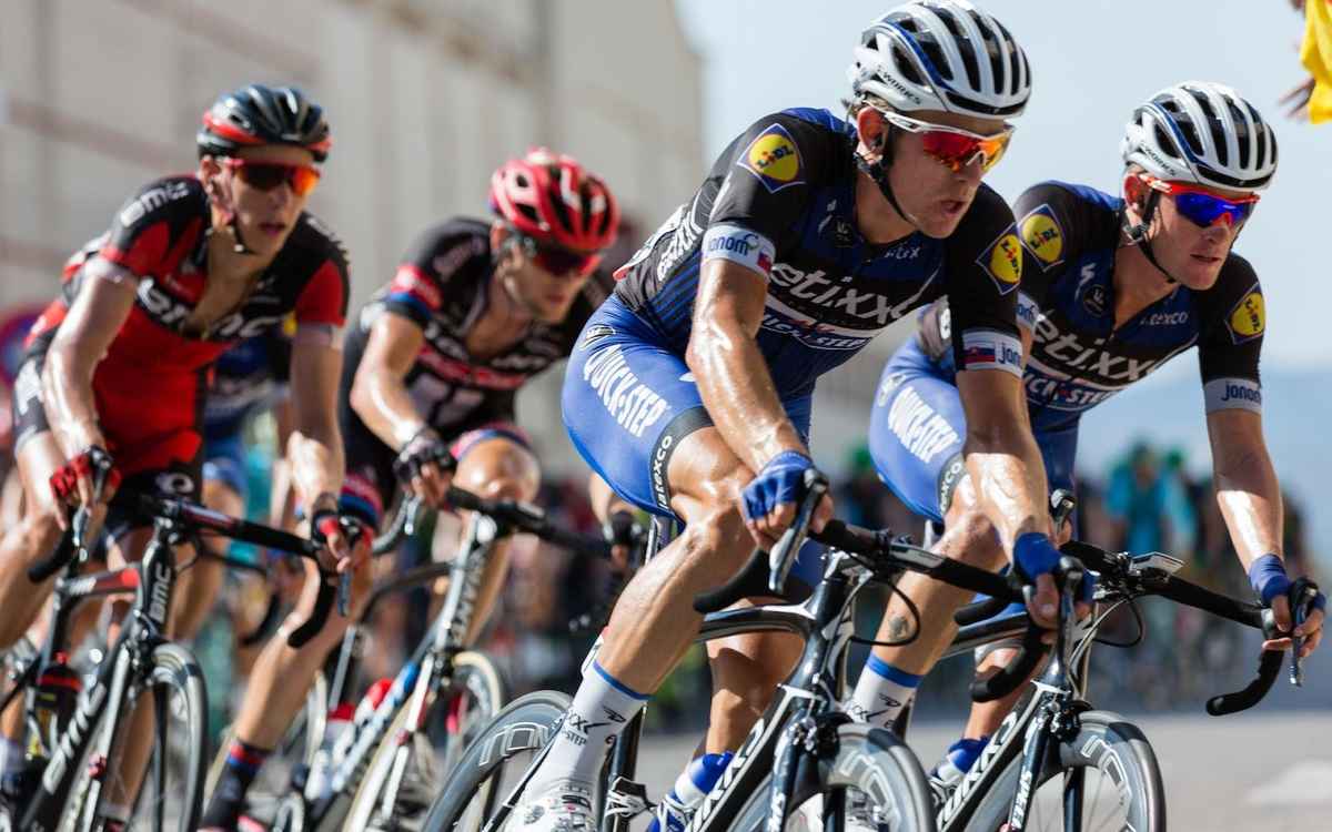 cyclists cycling with wraparound sunglasses on