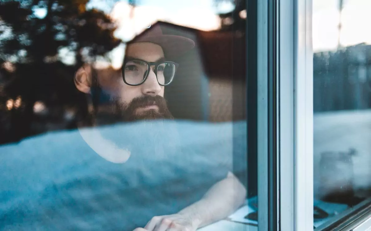 man looking through a window