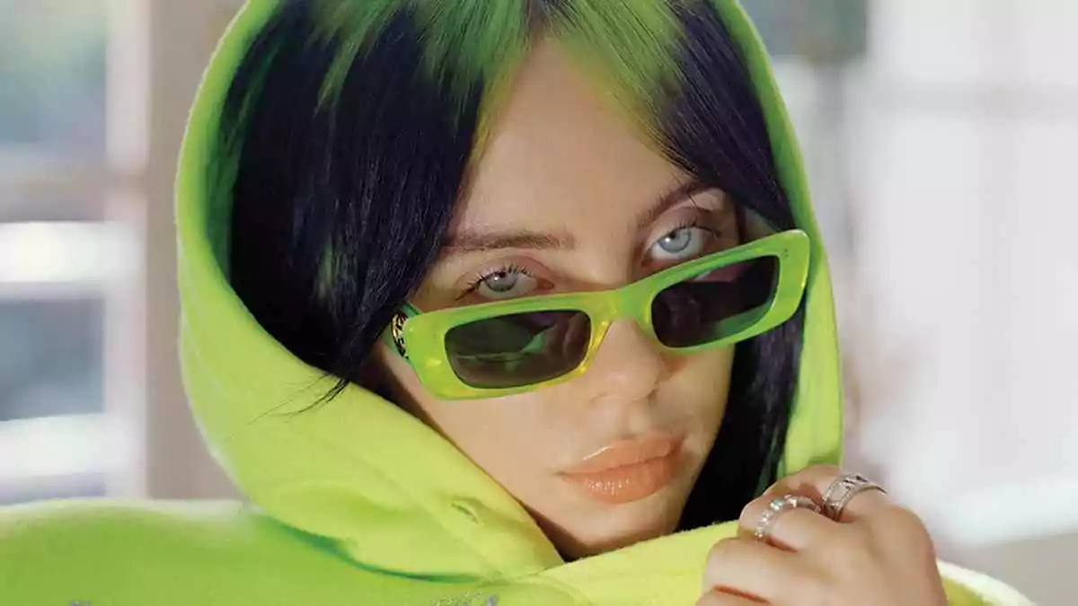Billie Eilish wears neon green glasses for the e-girl aesthetic