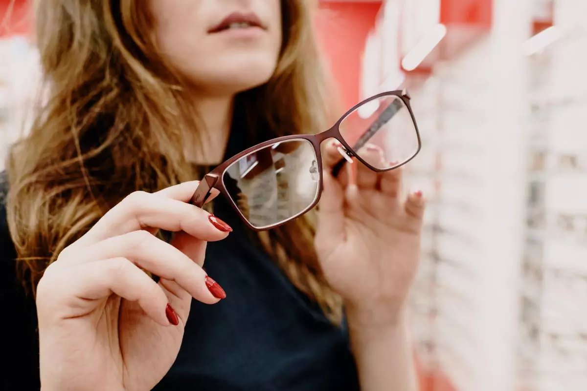 woman holding glasses