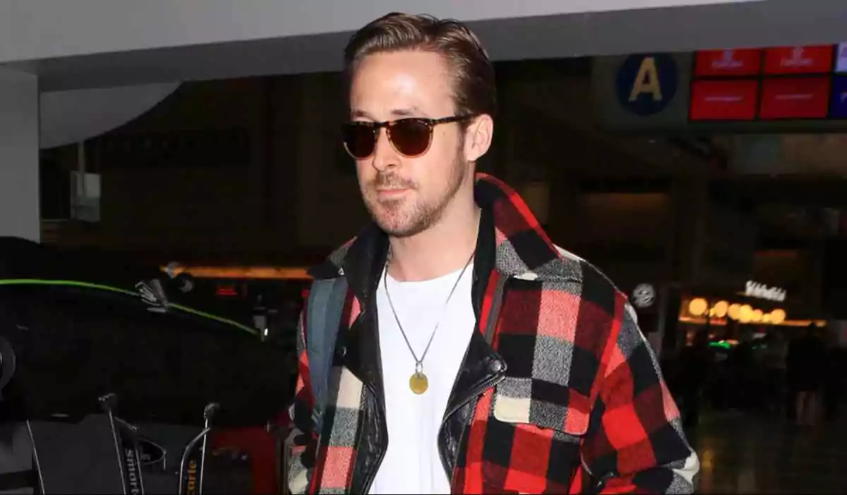 Ryan Gosling wears square brown sunglasses while exiting the airport