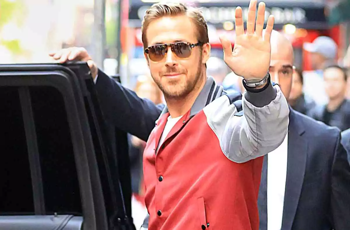 Ryan Gosling wears square tortoiseshell glasses paired with a varsity-style jacket