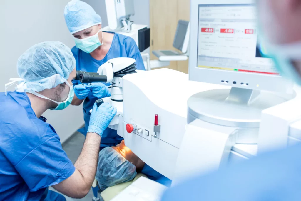 surgeons performing laser eye surgery on a patient