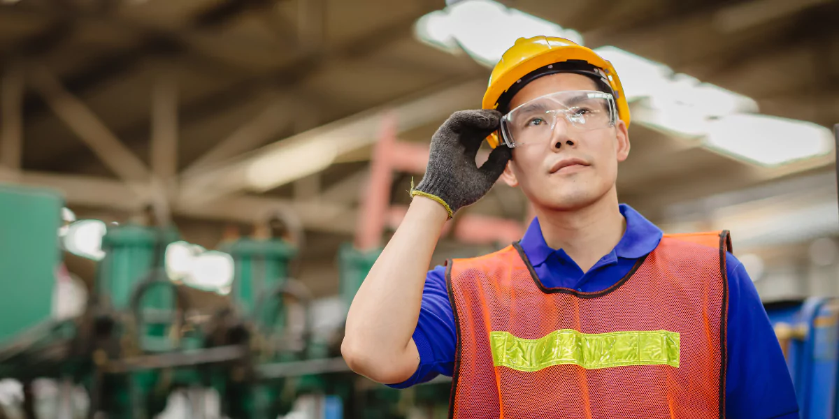 man wears safety eyewear in a manufacturing plant