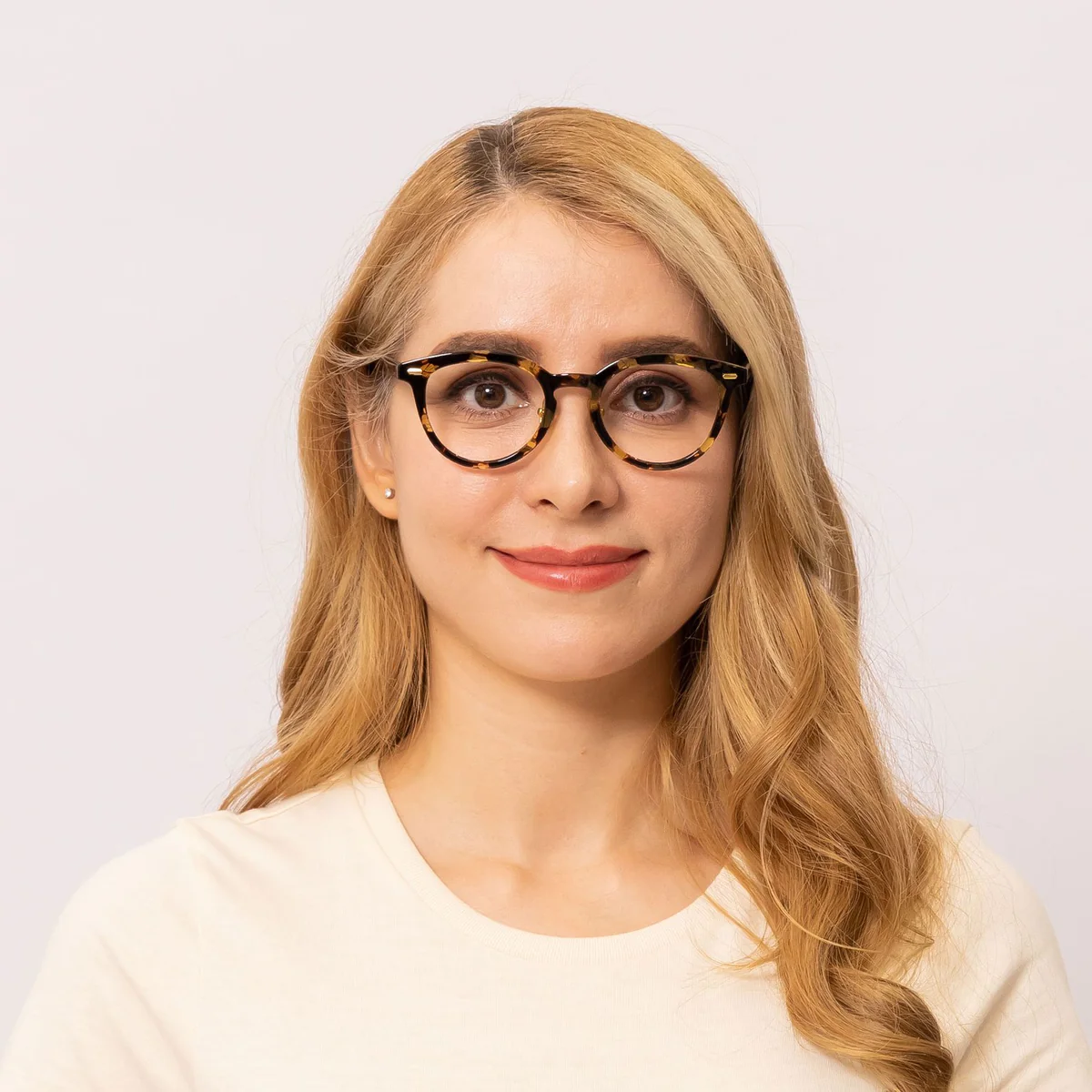 woman wears tortoise shell glasses frame