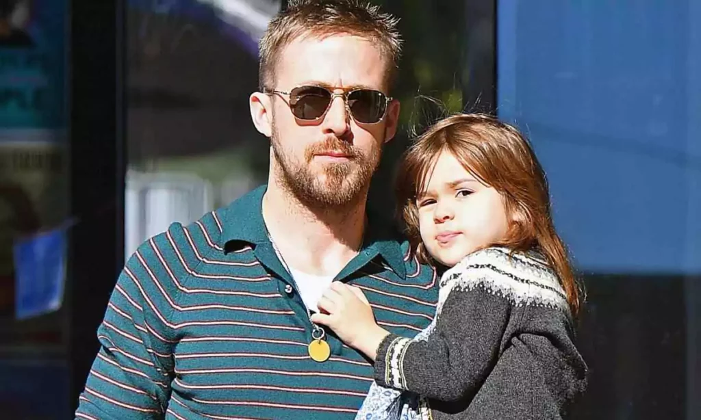 ryan gosling wears dad sunglasses while carrying his daughter