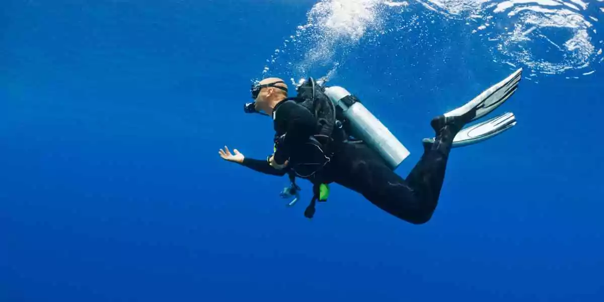 a diver with full gear underwater