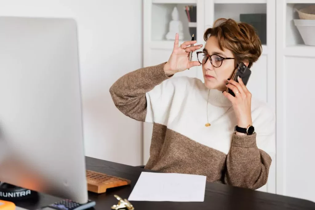 woman with glasses on the phone