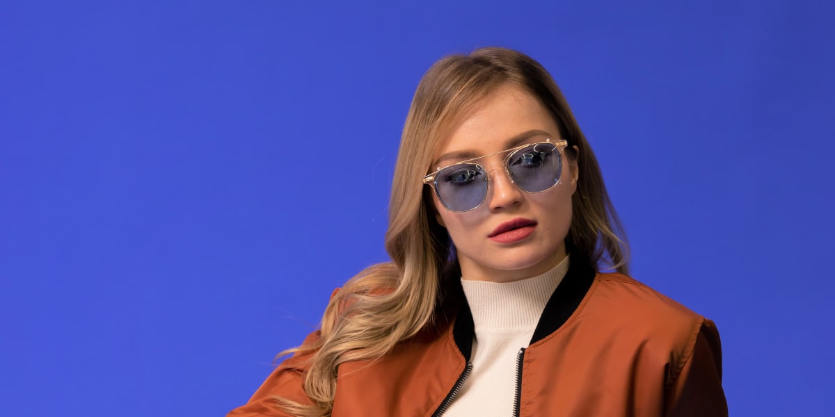 woman wears sunglasses with blue tinted lenses