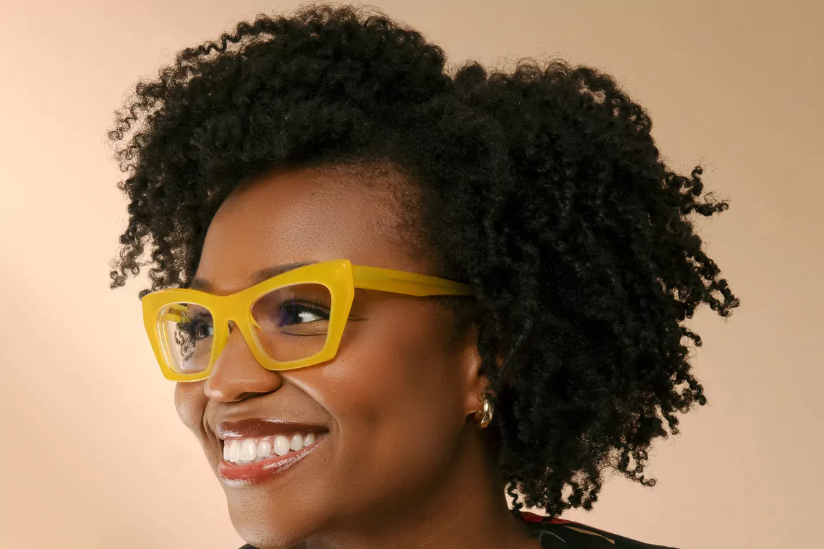 woman wears yellow glasses